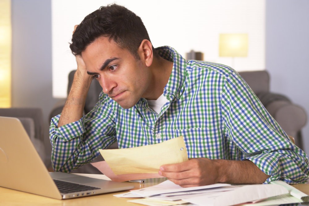 man staring frustrated at his computer